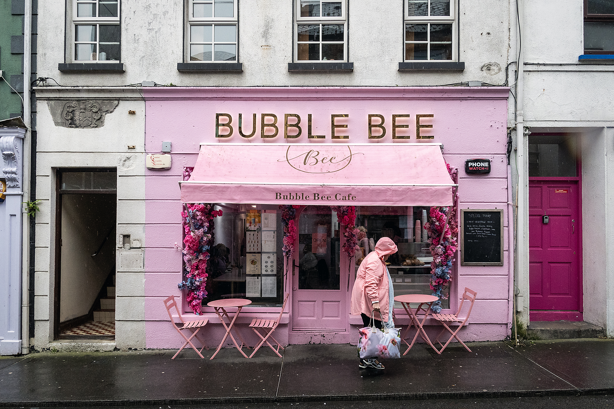 Pink storefront on rainy day